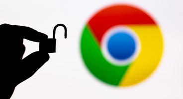 A hand is holding an opened padlock. In the background, there is a blurred Google Chrome logo.