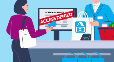 A person stands at a supermarket check out. She is holding a loyalty card. On the screen before here, there's her purchases listed. Above, there's "Access Denied" written.