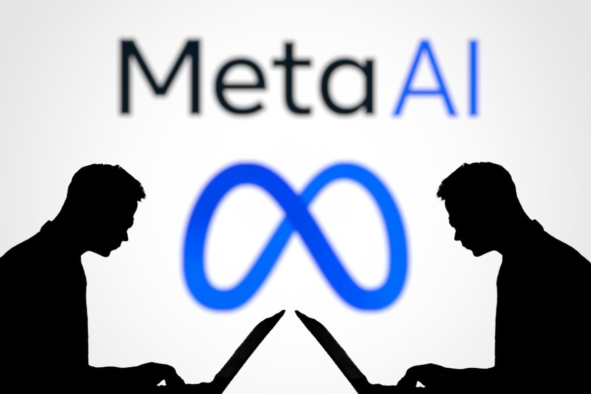 Two people sitting at laptops. In the background you can see the Meta logo and the slogan "Meta AI".