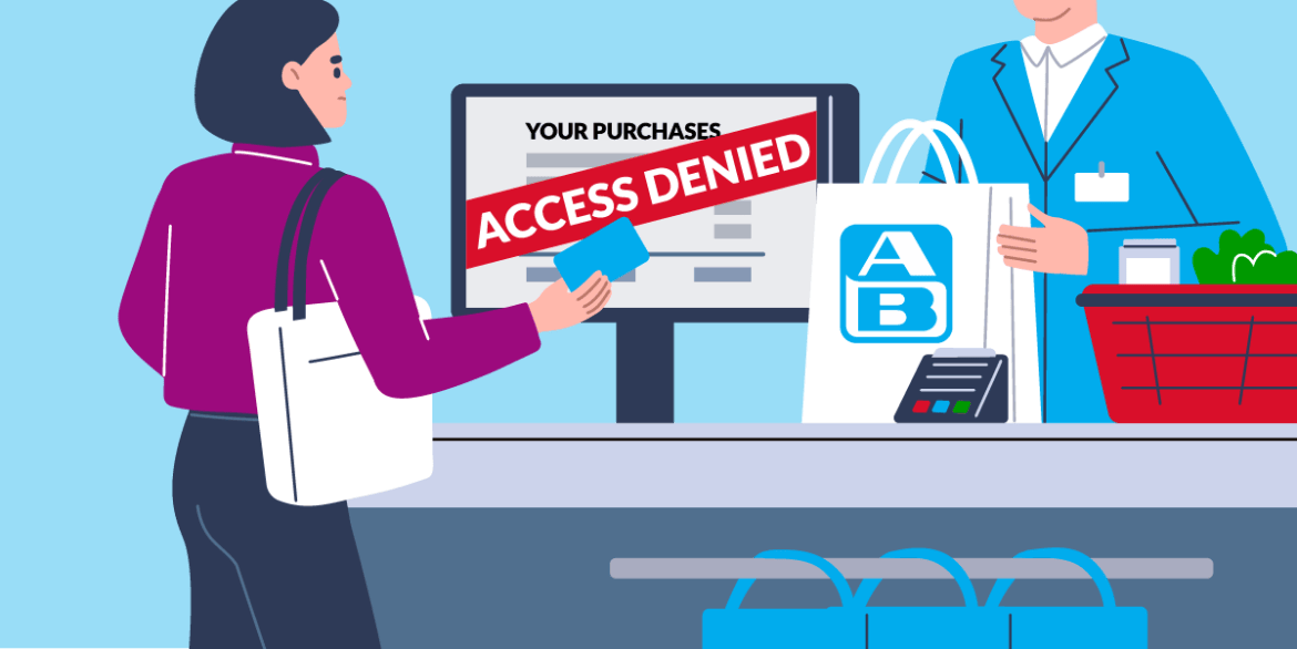 A person stands at a supermarket check out. She is holding a loyalty card. On the screen before here, there's her purchases listed. Above, there's "Access Denied" written.